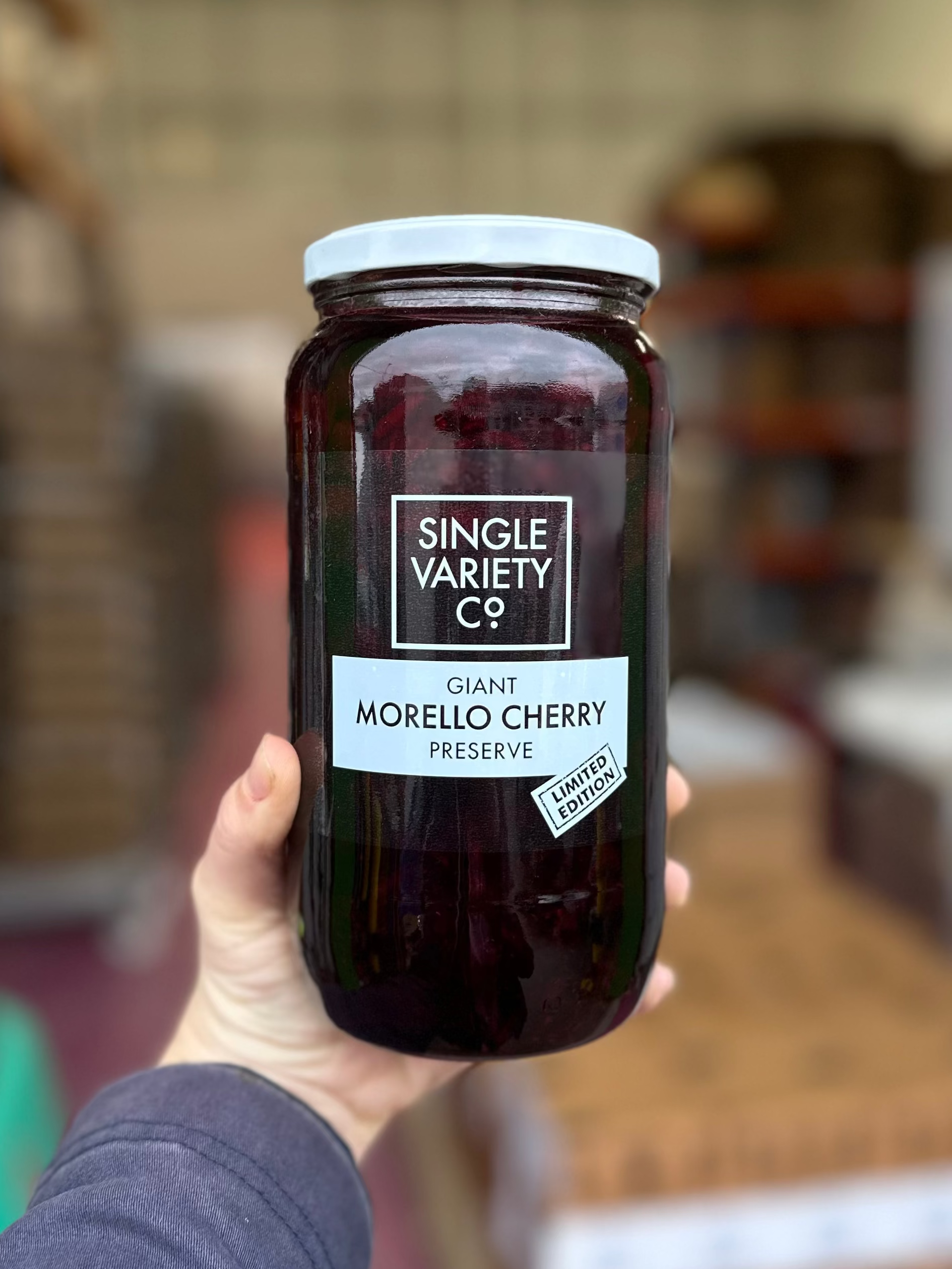 Hand holding a jar of &